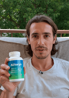 John holding a bottle of Alitoryn